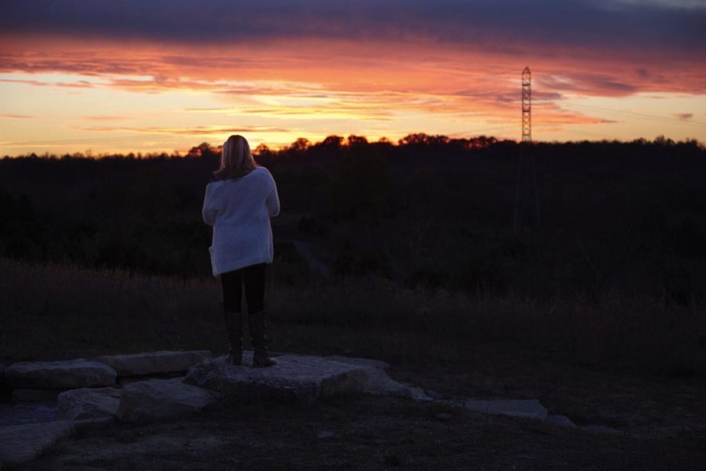 A woman enjoys a sunset